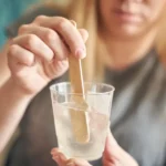 caucasian-female-adult-mixing-resin-art-craft-material-clear-cup-diy-project-354743382