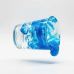 epoxy-resin-mixing-cup-floating-mid-air-horizontally-solid-white-background-402248449